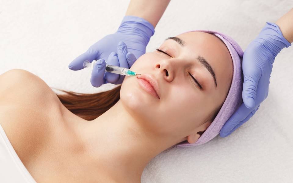 Woman receiving a cosmetic facial injection.