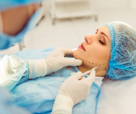 Patient receiving a cosmetic facial injection in a clinic.