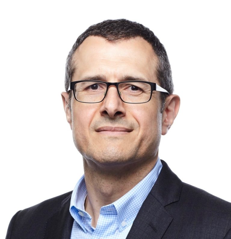 Professional man wearing glasses and a suit jacket.