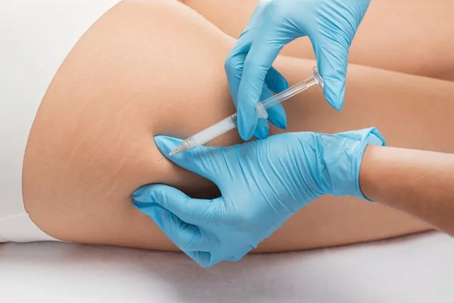 A medical professional administering an injection into a patient's buttock.