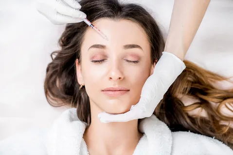 Woman receiving a cosmetic facial injection treatment.