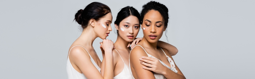 Three diverse women with flawless makeup and natural beauty.