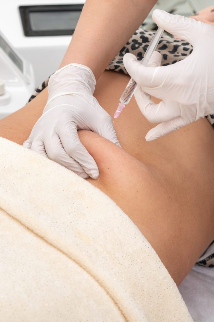 A medical professional administering an injection into a patient's arm.