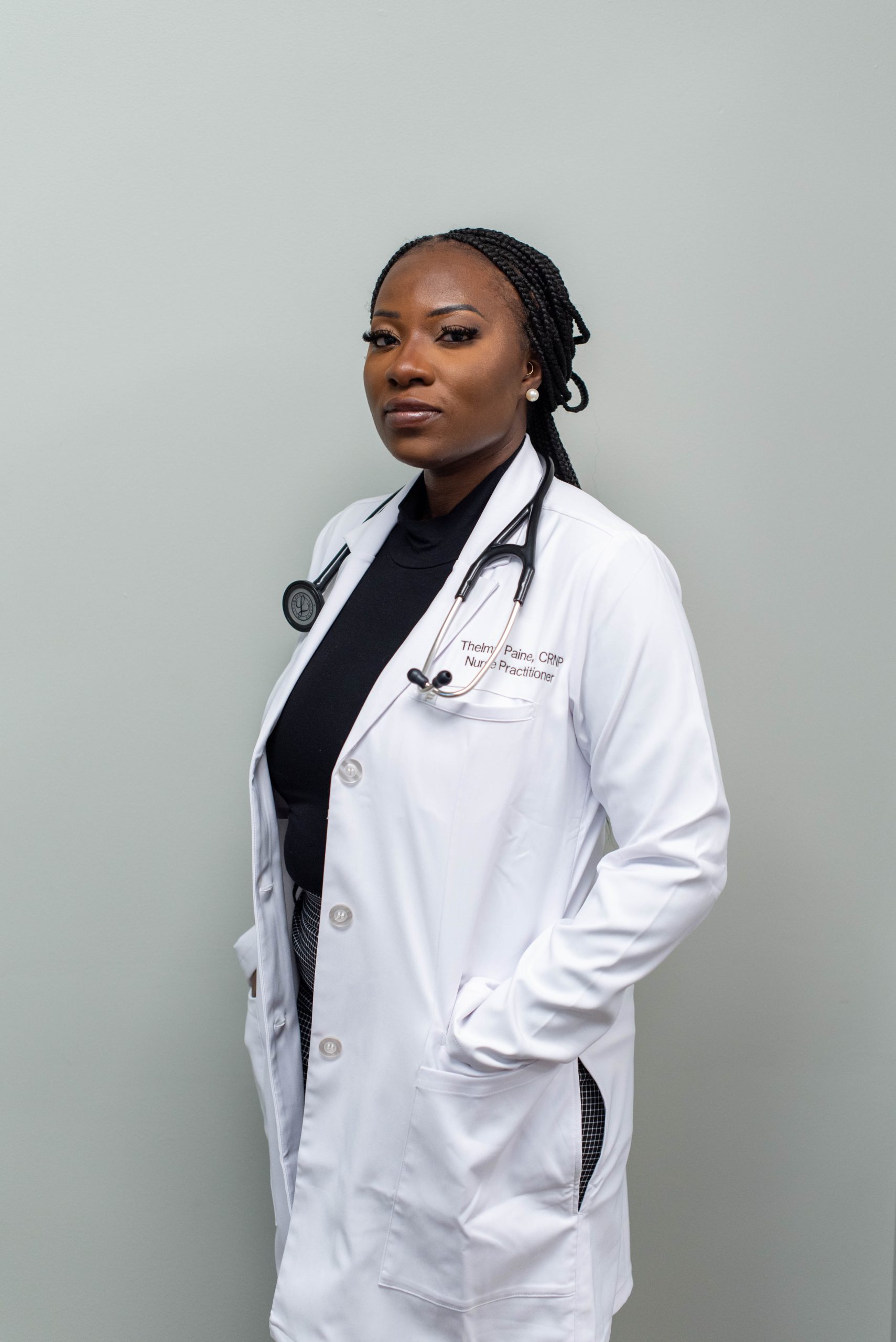 Confident female doctor in a white coat with a stethoscope.