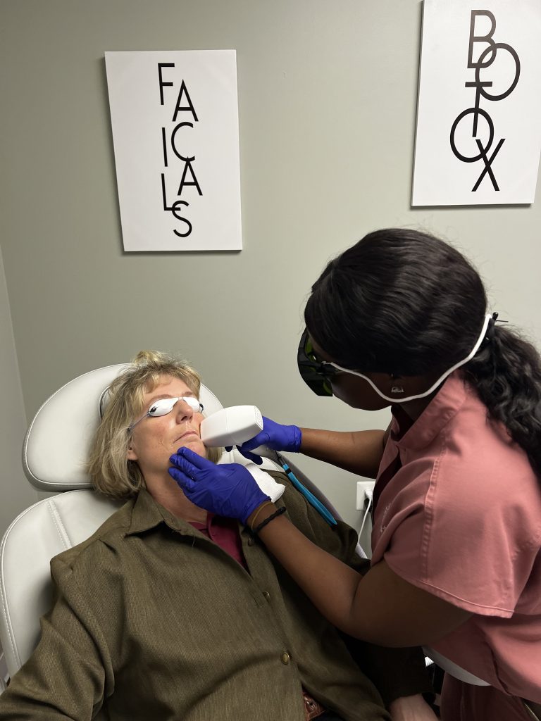 A dental professional treating a patient wearing protective eyewear.